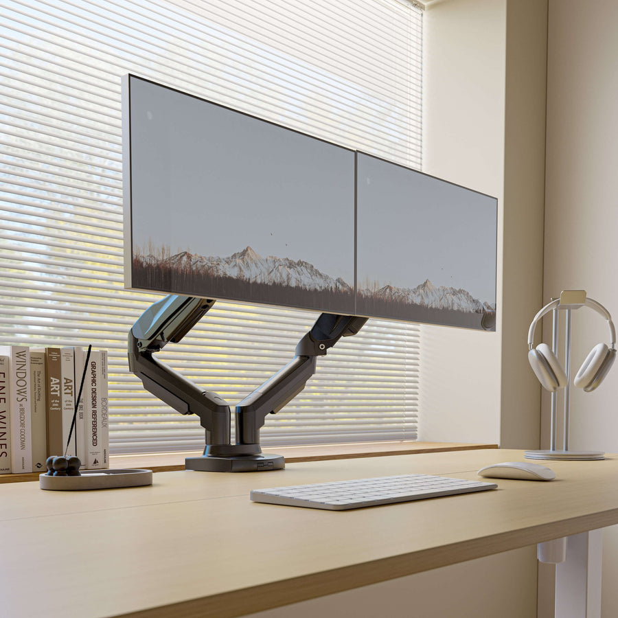 Two monitors on a HUANUO dual monitor arm on a desk